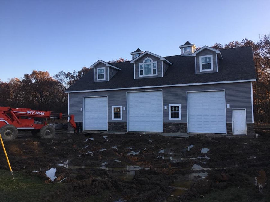 New construction detached garage with custom roofing and siding by McNeill Construction in Fenton, MI