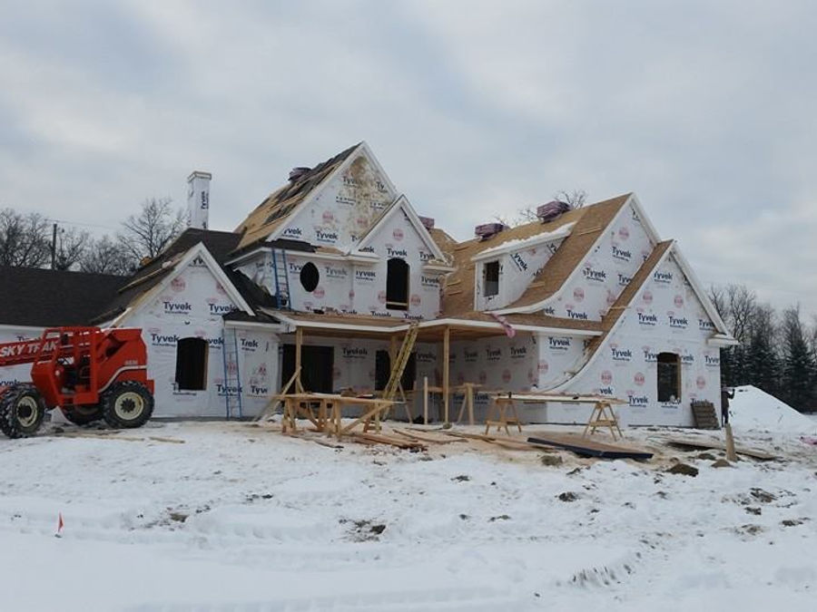 Roofing and framing work on a custom home by McNeill Construction roofing contractors in Fenton, MI